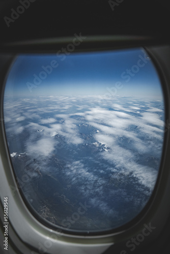 aerial view from airplane window on snow covered mountains
