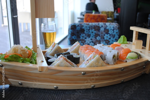 Sushi and rolls set in Boat bar from reclaimed wood  with a glass of beer in a seafood restaurant © Natalia Hanin