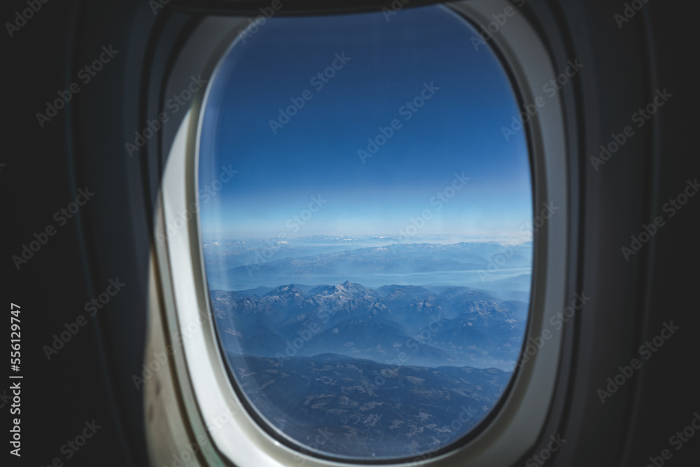 view on rocky mountains from airplane window view on rocky mountains from airplane window