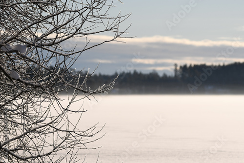 Beautiful and peaceful scenery at snowy frozen lake in Finland
