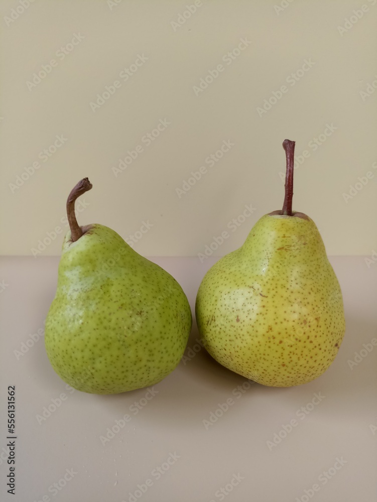 two green pears on cream and beige background two green pears on cream and beige background