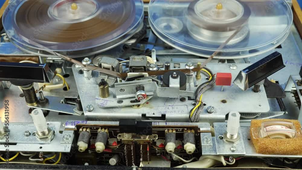 Rewinding the Reel Tape of an Old Mechanical Tape Recorder With Reel. Rewinding the Reel Tape of an Old Mechanical Tape Recorder With Reel.