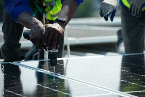 Both of Engineer in charge of solar panel installation The installation of solar energy conversion into electricity for a warehouse is currently being investigated.