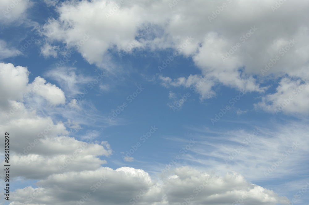 White clouds against the blue sky. Sunny day. White clouds against the blue sky. Sunny day.