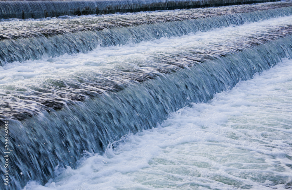 A close-up of a waterfall descending from a lake. A close-up of a waterfall descending from a lake.