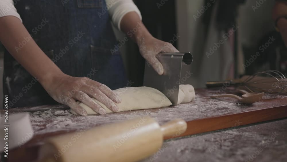 baker divides the dough into portions and weights to hand make bread baker divides the dough into portions and weights to hand make bread
