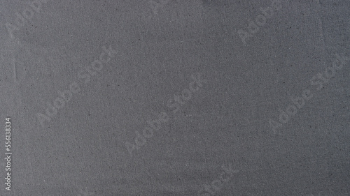 Abstract background of stretched gray natural fabric.