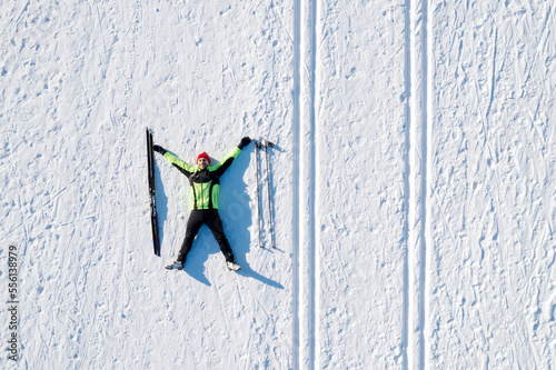 Skier cross-country skiing in snow forest. Winter competition, Aerial top view