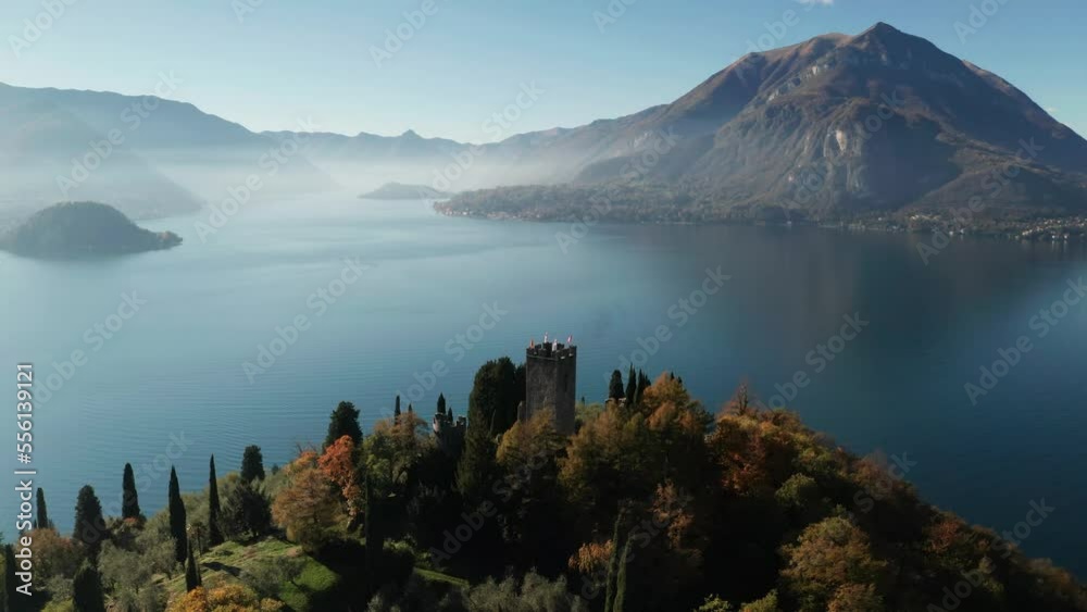 Scenic aerial view of Vezio Castle, above the Varenna town, at the center of Lake Como in northern Italy. Vezio castle is an ancient military outpost of early medieval origin