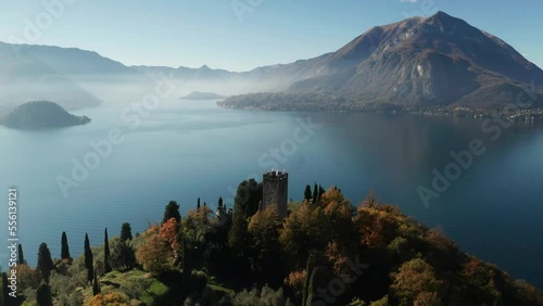 Scenic aerial view of Vezio Castle, above the Varenna town, at the center of Lake Como in northern Italy. Vezio castle is an ancient military outpost of early medieval origin
