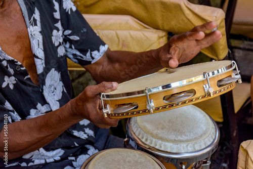 Detail of musician playing tambourine in the streets of Pelourinho in Salvador in Bahia during a samba performance at Carnival