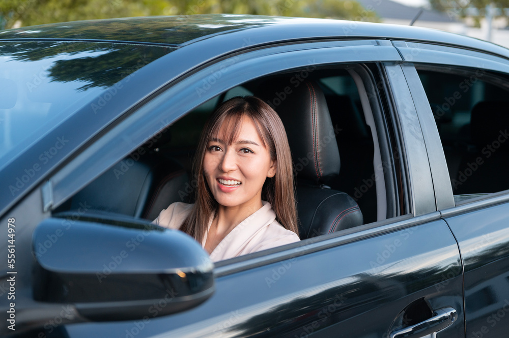 Young asian beautiful woman driving a car with fastened seatbelt