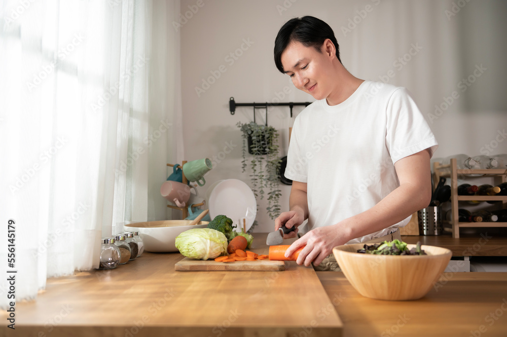 An Asian young man cooking , preparing breakfast with healthy food in kitchen at home , healthy lifestyle An Asian young man cooking , preparing breakfast with healthy food in kitchen at home , healthy lifestyle
