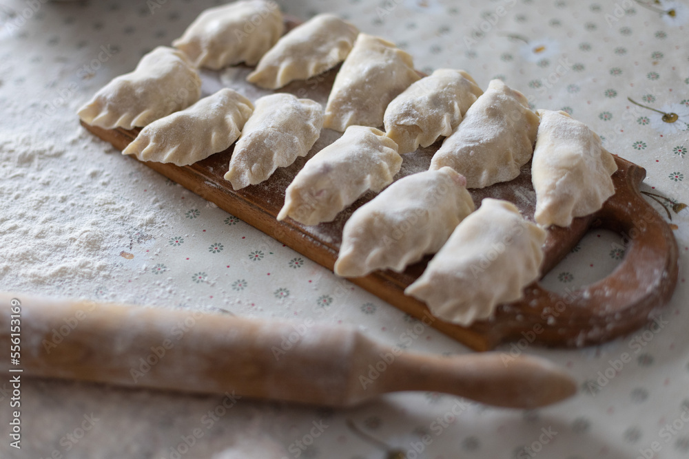 Homemade raw dumplings with cherries. Cooking at home. Selective focus. Homemade raw dumplings with cherries. Cooking at home. Selective focus.