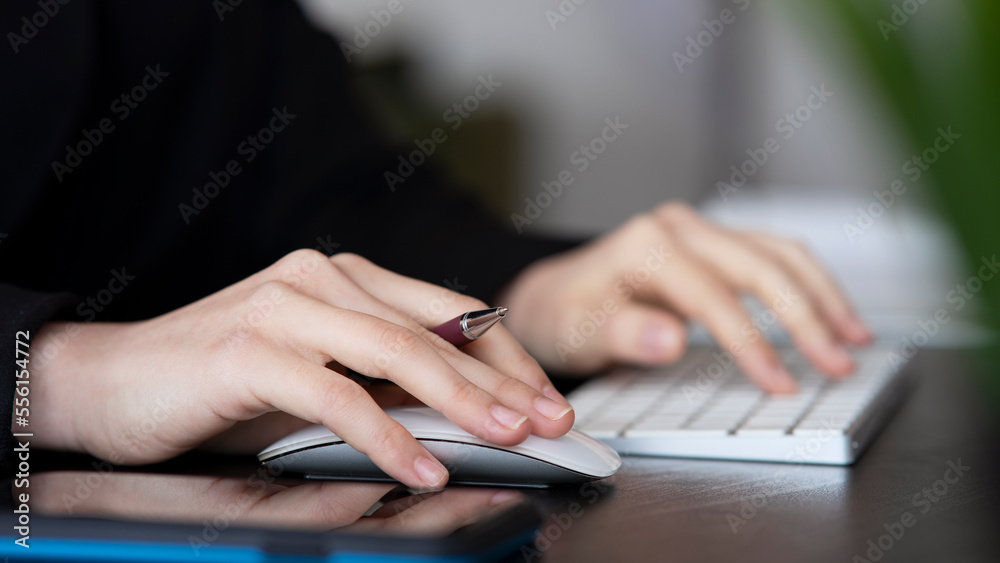 Female office worker typing on the keyboard Female office worker typing on the keyboard