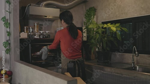 Wallpaper Mural Asian baker putting dough in the oven to hand make bread Torontodigital.ca