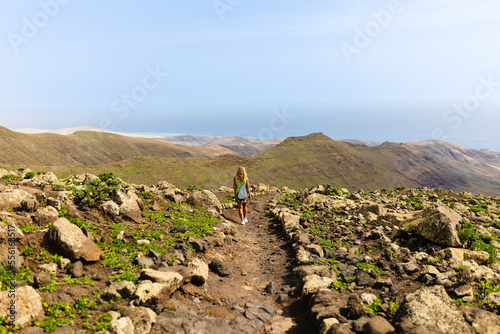 A young slender traveler on a hiking trail to Pico la Zarza, the highest peak in Fuerteventura, Spain.