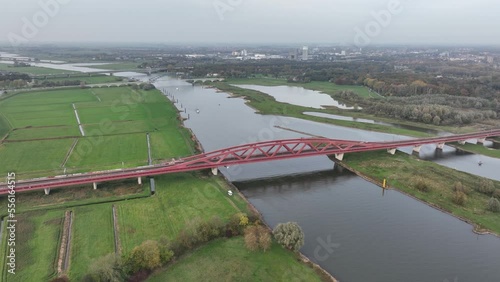 The Hanzeboog railway bridge near Zwolle over the river IJssel part of the railway line Utrecht Kampen and the railway line Lelystad Zwolle. Aerial drone overview. photo