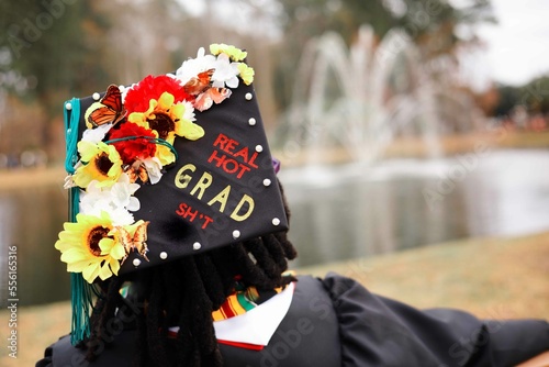 Woman wearing graduation cap with flowers on it