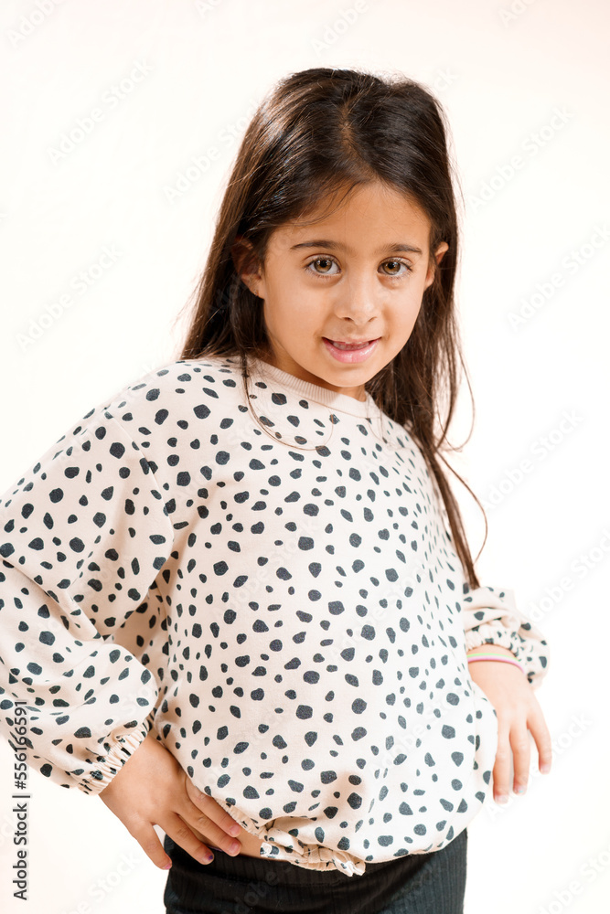 Beautiful young girl posing with hands on hips and a sassy expression