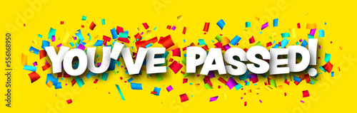 You've passed sign over cut out ribbon confetti background.