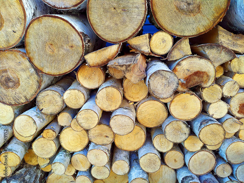 Photo of stacks of logs made of natural wood. Background. Harvesting firewood for the winter. Heated houses. Texture. Firewood for the fireplace. Birch boards. Macrosymka. Copy space