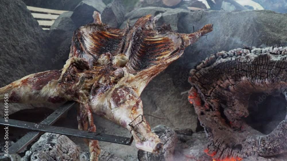 rustic lamb barbecue bbq over open fire in Patagonia, Argentina, South America. Asado is a Gaucho traditon with cooking on open flame rustic lamb barbecue bbq over open fire in Patagonia, Argentina, South America. Asado is a Gaucho traditon with cooking on open flame