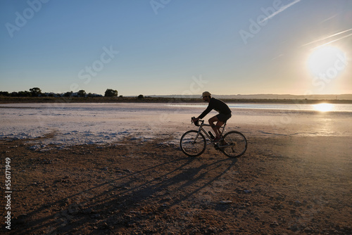 Man riding on gravel bike. Cyclist practicing on gravel roads. Sport motivation. Cycling life © Ketrin