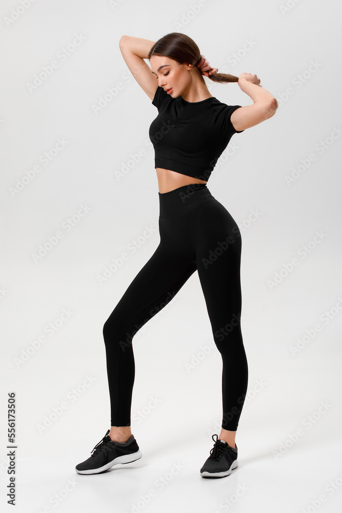 Fitness woman. Athletic girl on the gray background Fitness woman. Athletic girl on the gray background