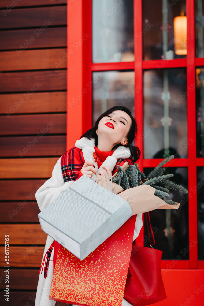 beautiful brunette with purchases and gifts for the family. winter city