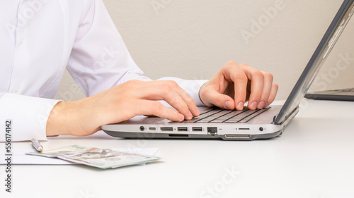Image of male hands typing on a laptop. close-up. selective focus