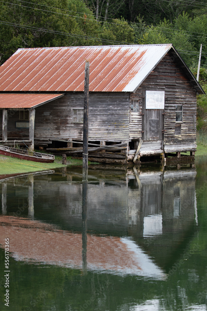 Fisheries shed with reflection in water at Sointula, Malcolm Island, British Columbia, Canada Fisheries shed with reflection in water at Sointula, Malcolm Island, British Columbia, Canada