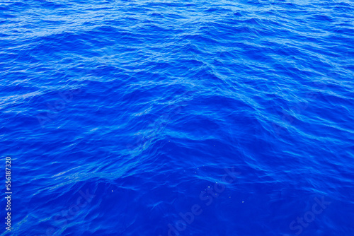 Very nice sea water background or backdrop with selective focus. Small waves of natural water surface texture.