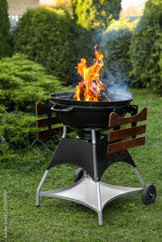 Portable barbecue grill with fire flames outdoors