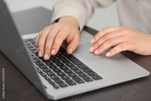 Fototapeta Naklejka Na Ścianę i Meble -  Woman working on laptop at table, closeup. Electronic document management