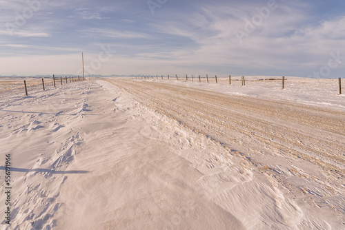 Snow covered gravel road in the remote prairies, Alberta, Canada