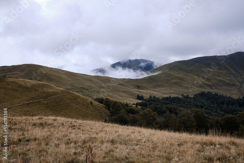 Mountain landscape. Beautiful sunny day in the mountains. Low clouds in mountains Carpathian mountains in Romania