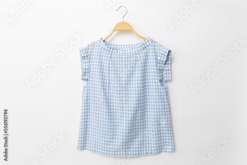 Blue colour blouse is clothes hanger on white background.linen fabric.