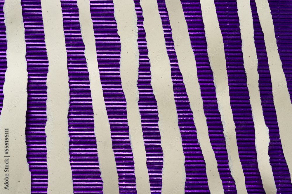 torn paper ribbons on purple metallic foil corrugated paper backdrop torn paper ribbons on purple metallic foil corrugated paper backdrop