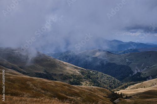 Mountain landscape. Beautiful sunny day in the mountains. Low clouds in mountains Carpathian mountains in Romania