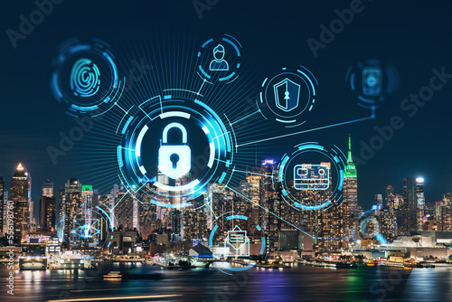 New York City skyline from New Jersey over the Hudson River with the skyscrapers at night, Manhattan, Midtown, USA. The concept of cyber security to protect confidential information, padlock hologram
