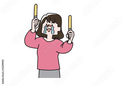 泣きながらペンライトをふって推しを応援する女性