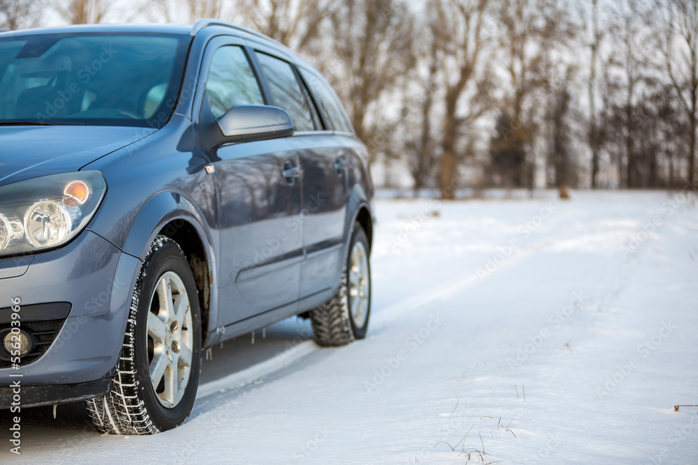 Car parked in snowy field on winter day. Car parked in snowy field on winter day.