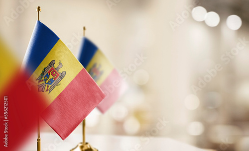 Small flags of the Moldavia on an abstract blurry background photo