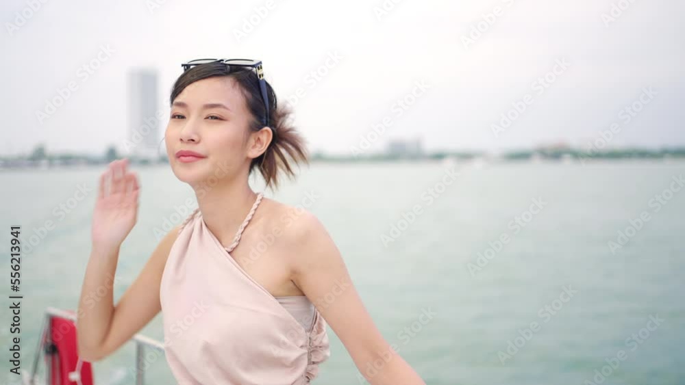 Portrait of Young attractive Asian woman passenger tourist enjoy and fun luxury outdoor lifestyle travel on private catamaran boat yacht sailing in the ocean on summer holiday tropical beach vacation. Portrait of Young attractive Asian woman passenger tourist enjoy and fun luxury outdoor lifestyle travel on private catamaran boat yacht sailing in the ocean on summer holiday tropical beach vacation.