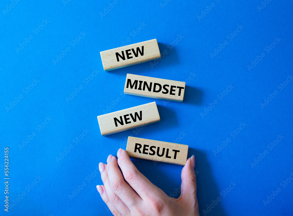 Mindset symbol. Wooden blocks with words New Mindset new Result. Businessman hand. Beautiful blue background. Business and New Mindset new Result concept. Copy space.