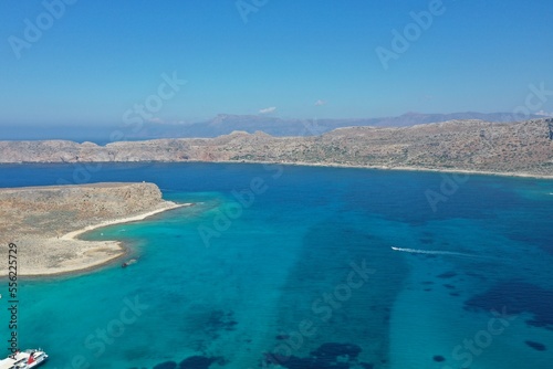 Aerial view of floating boat on blue sea at sunny day. © Rafik
