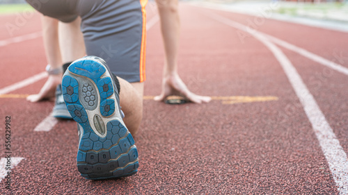 Athletic sport running man prepare start sprint run in running field