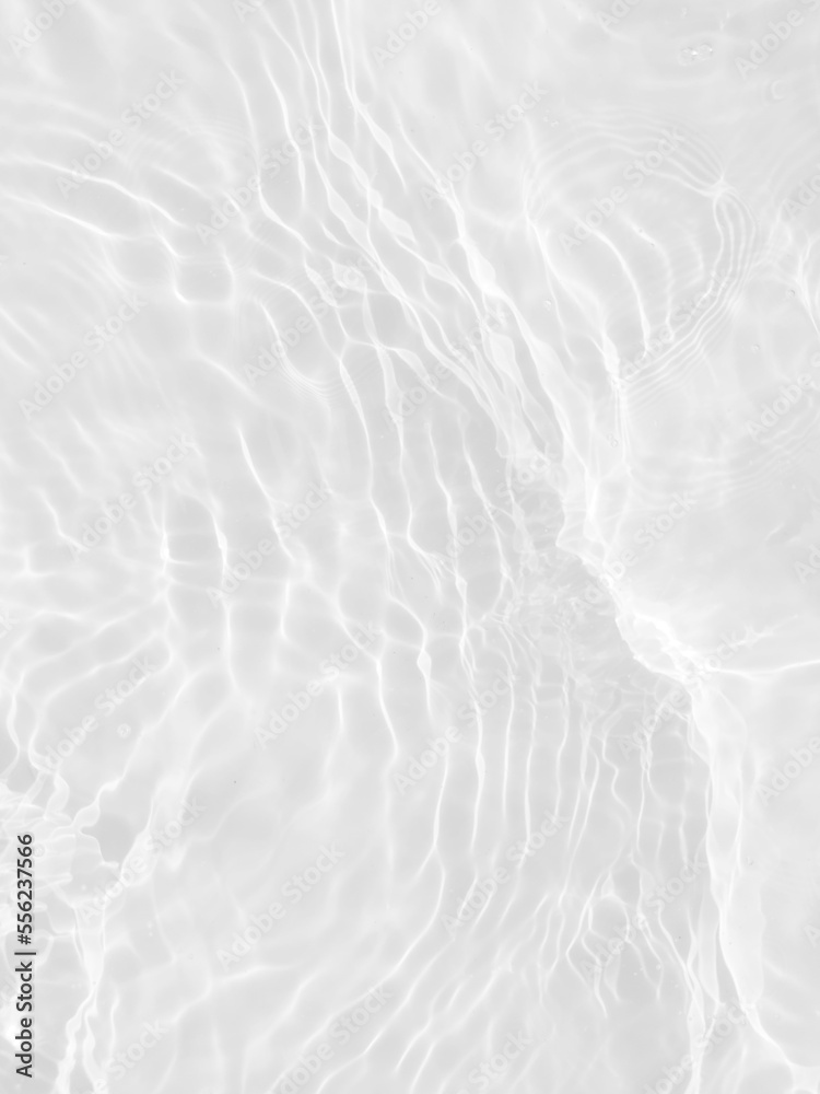 Fototapeta premium Defocus blurred transparent white colored clear calm water surface texture with splashes and bubbles. Trendy abstract nature background. Water waves in sunlight with copy space. White water shine