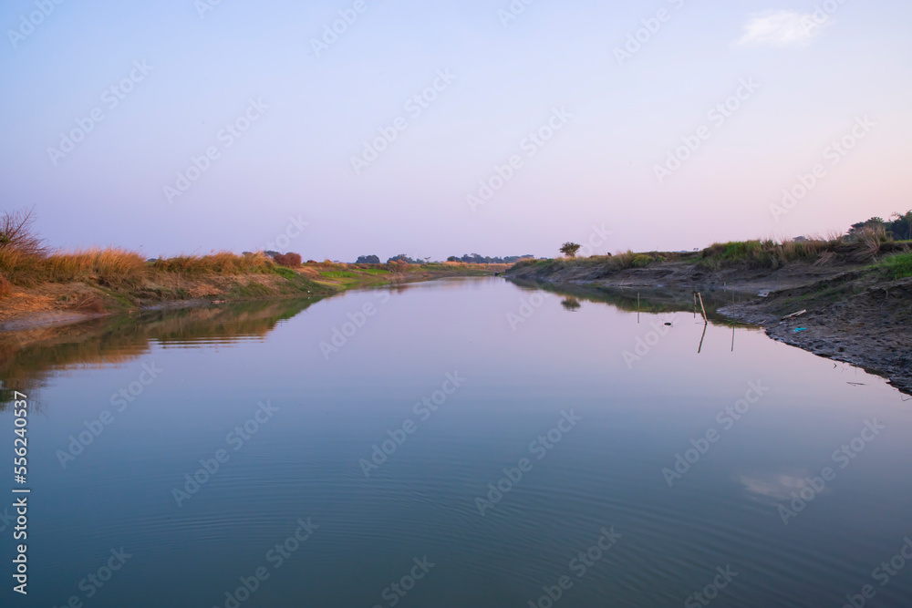 Arial View Canal with green grass and vegetation reflected in the water nearby Padma river in Bangladesh